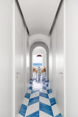 a hallway with a table and chairs