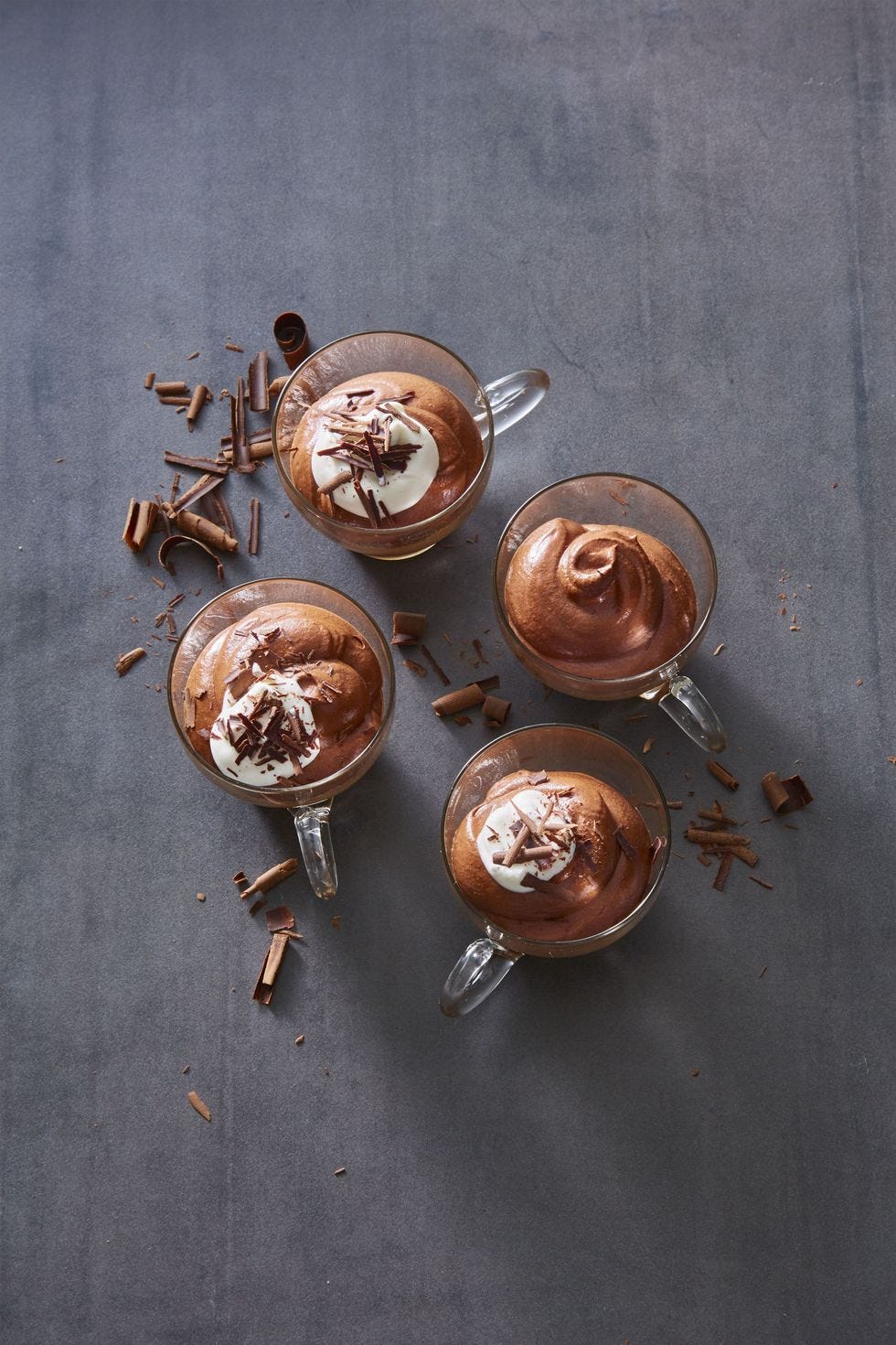 chocolate mousse with whipped cream and chocolate shavings in a glass mug