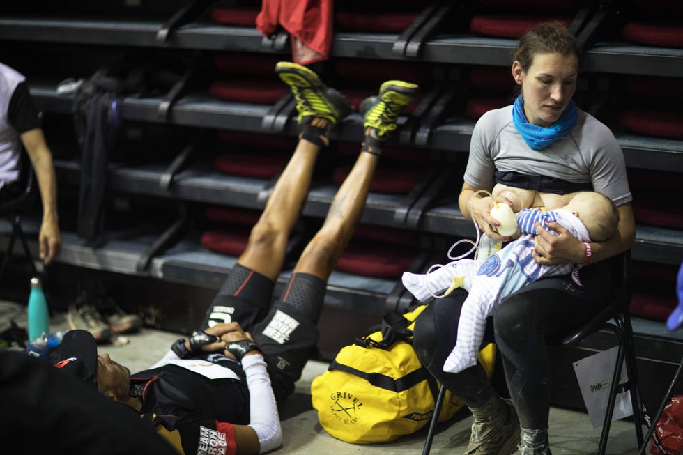 a resting area showing a parent breastfeeding and athletes in recovery