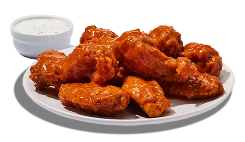 plate of chicken wings with a dipping sauce