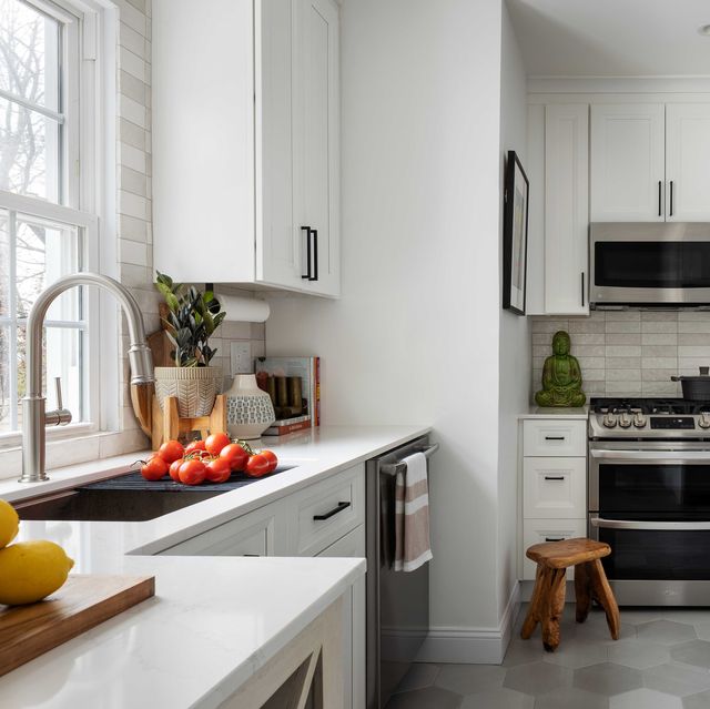 white kitchen, oven, wooden step stool, silver faucet, white countertops