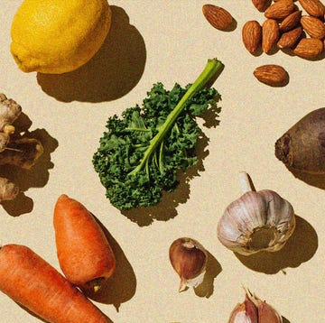 a variety on fruit vegetables and nuts laid out on a pale yellow background