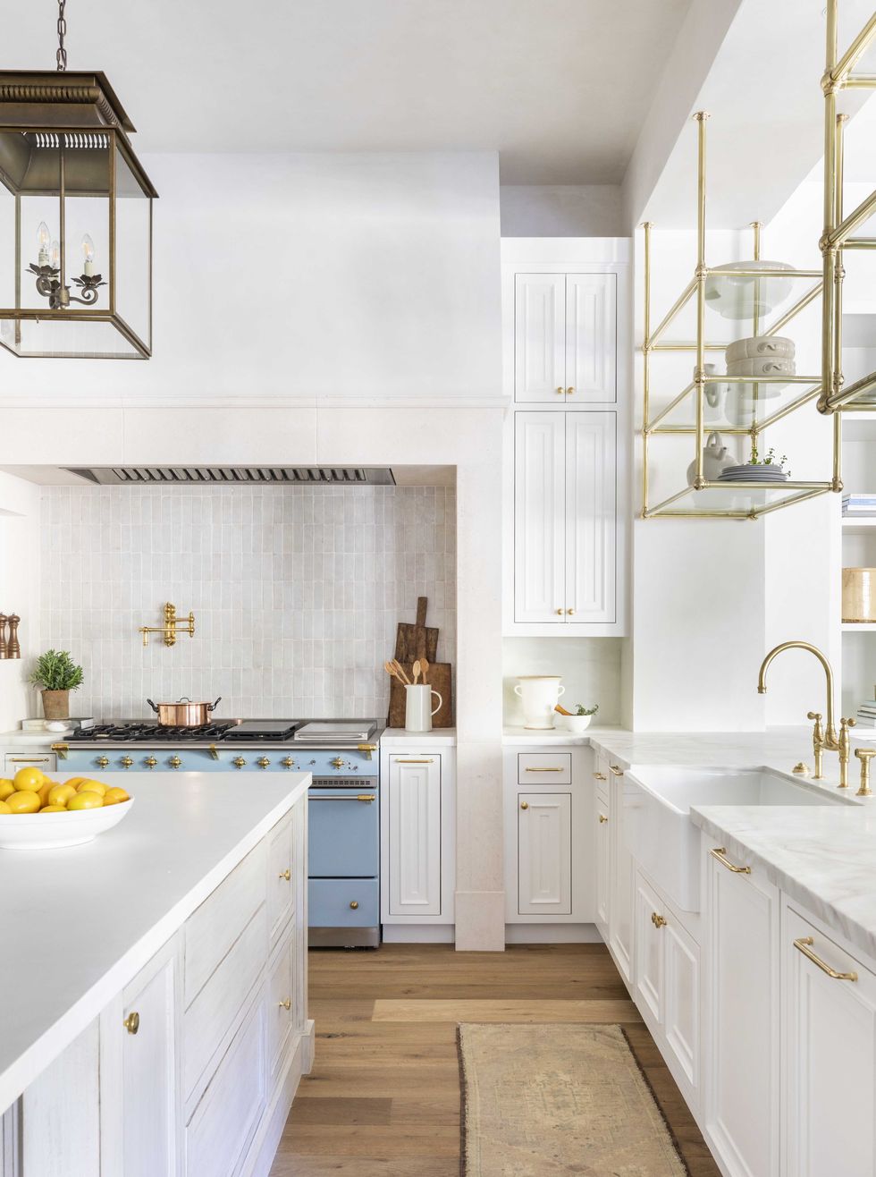 white kitchen, white cabinets, marble countertop, light blue stove