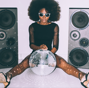 woman in front of speakers and disco balls