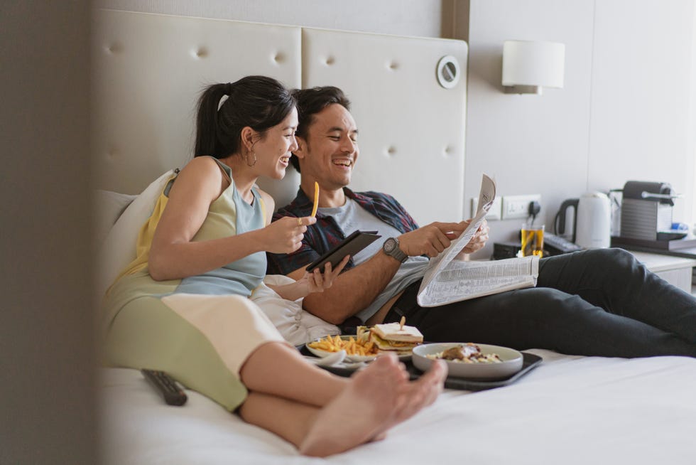 couple enjoying in room service and breakfast in bed