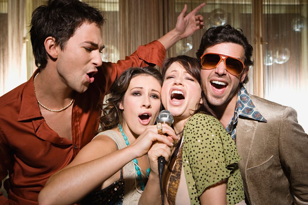 a group of people singing karaoke