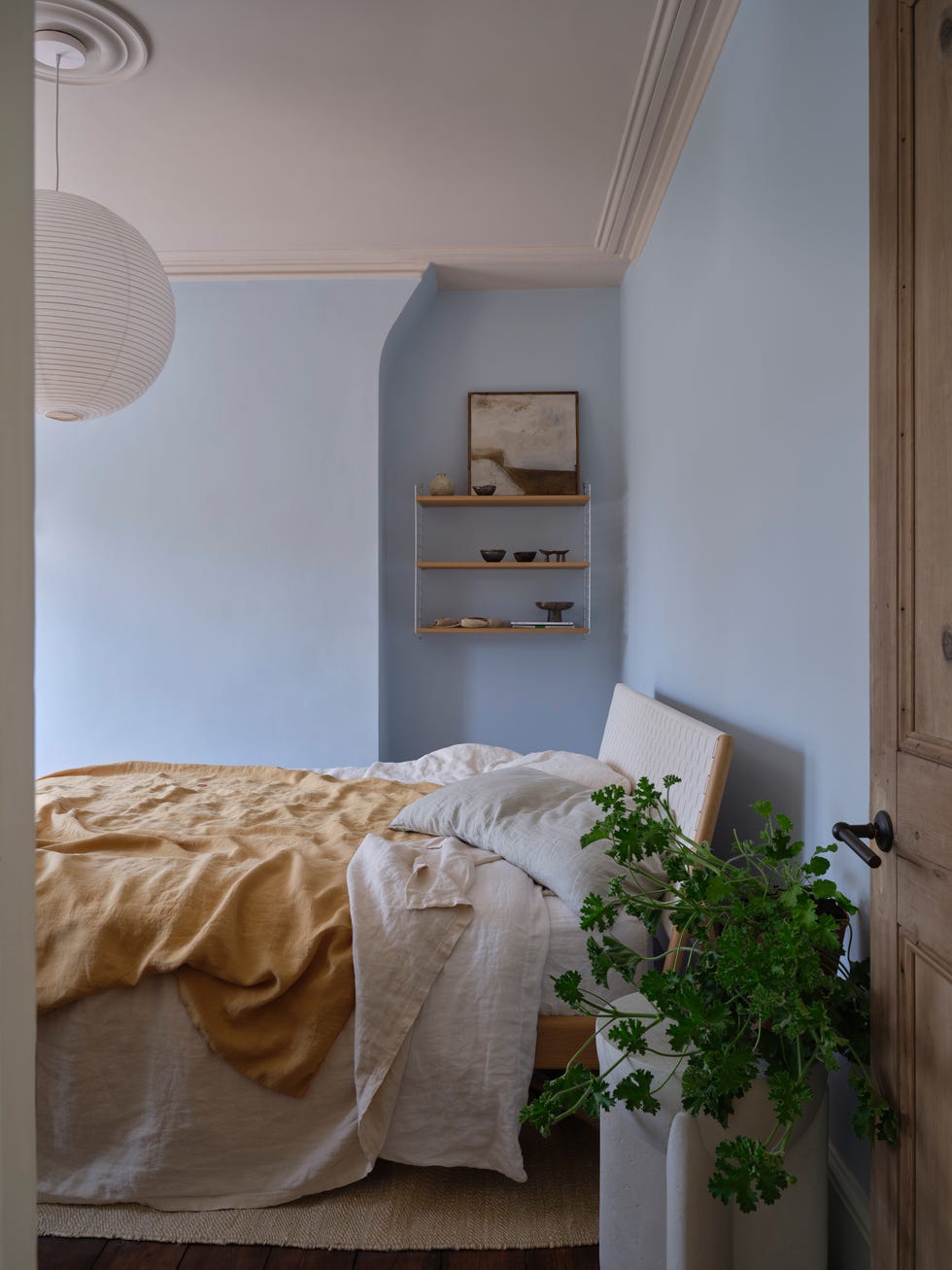 A cozy bedroom showcasing soft textiles and natural elements