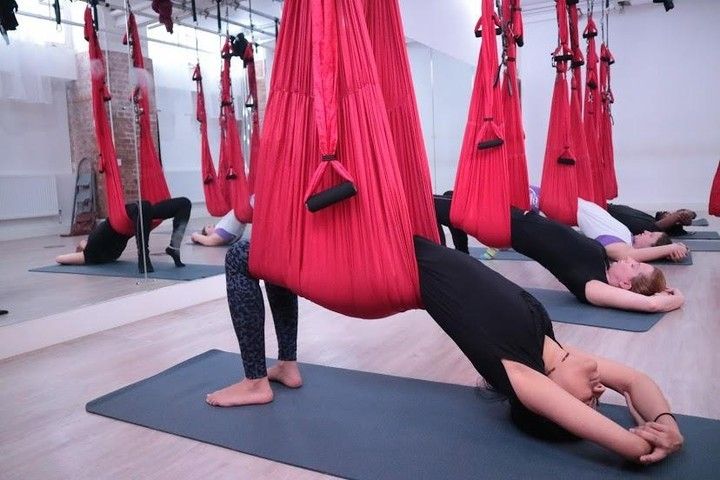women doing aerial yoga