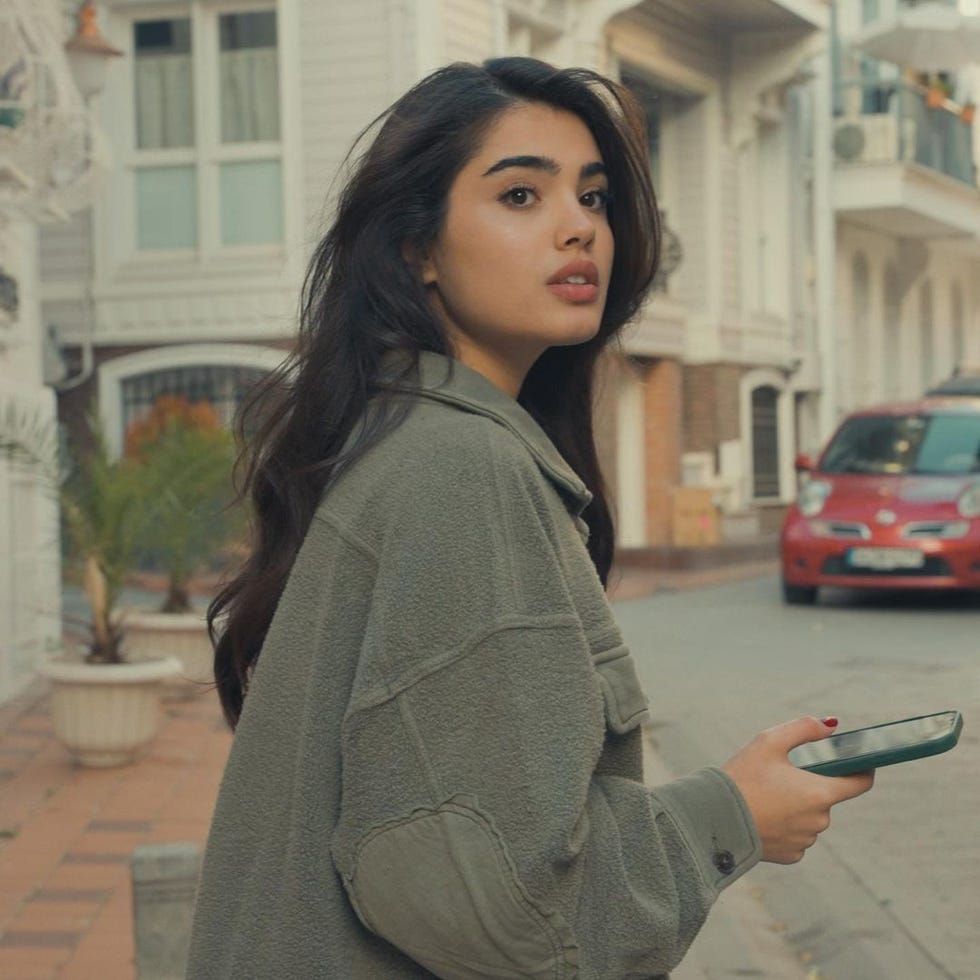 a woman holding a phone