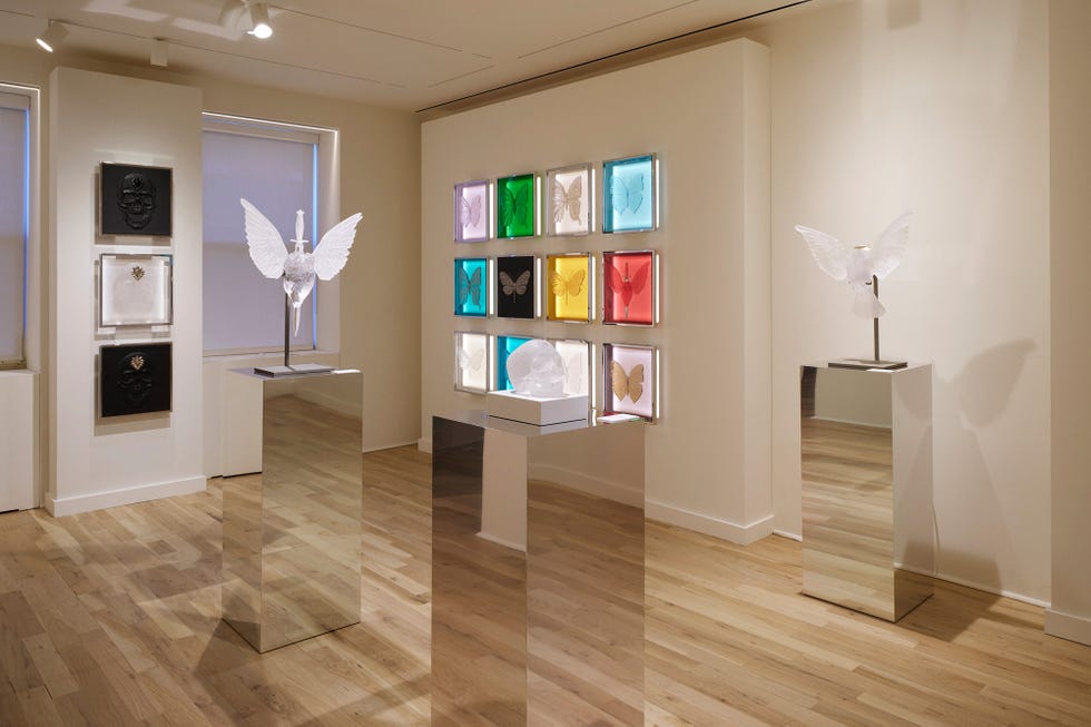 Contemporary art exhibition featuring sculptures and framed artworks.