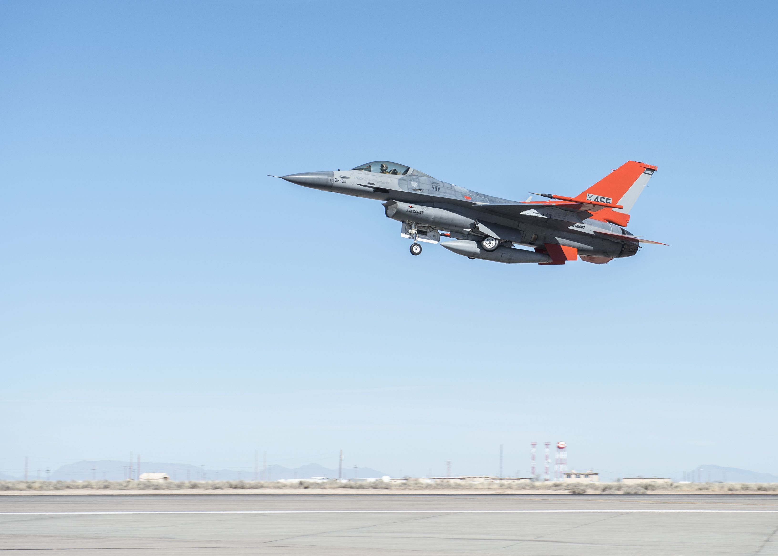 A pilot remotely controls a Q-F4 Phantom as it takes off from the