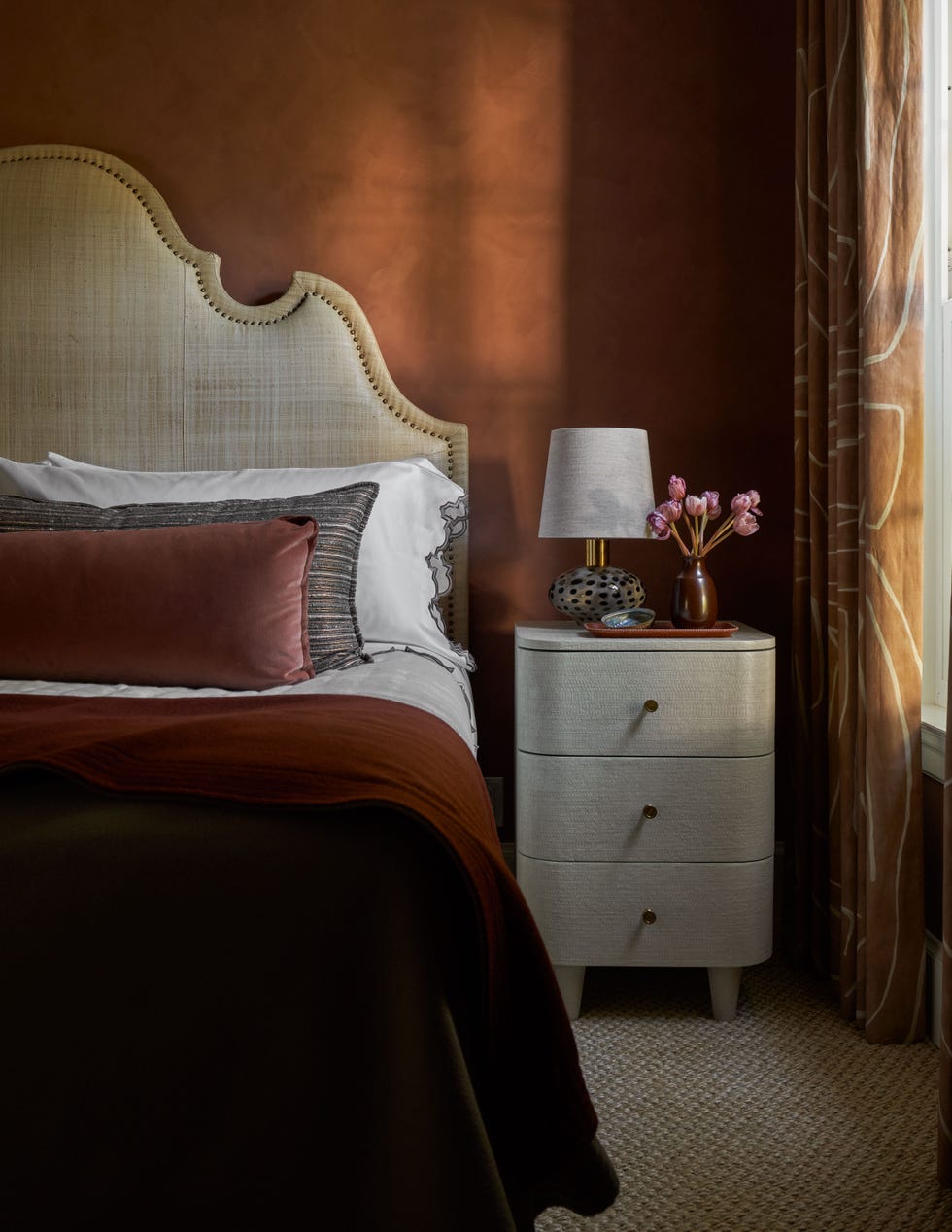 a bed with a red comforter
