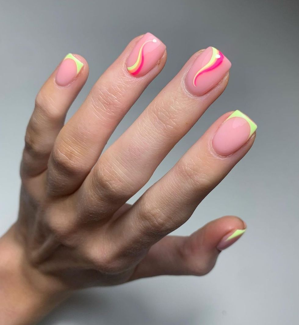 a person's hand with painted nails