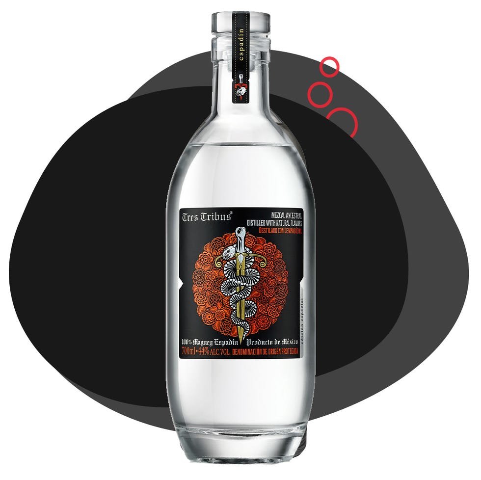 bottle of tres tribus mezcal with a decorative label