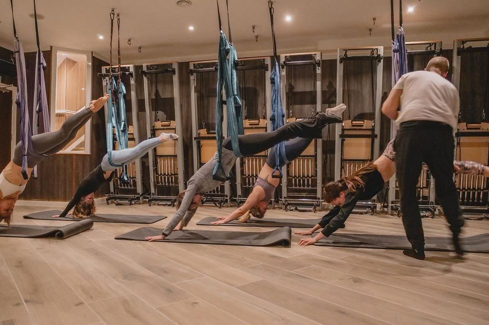 women doing aerial yoga