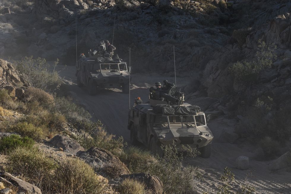 two humvees are dressed up to appear as brdm 2 reconnaissance vehicles