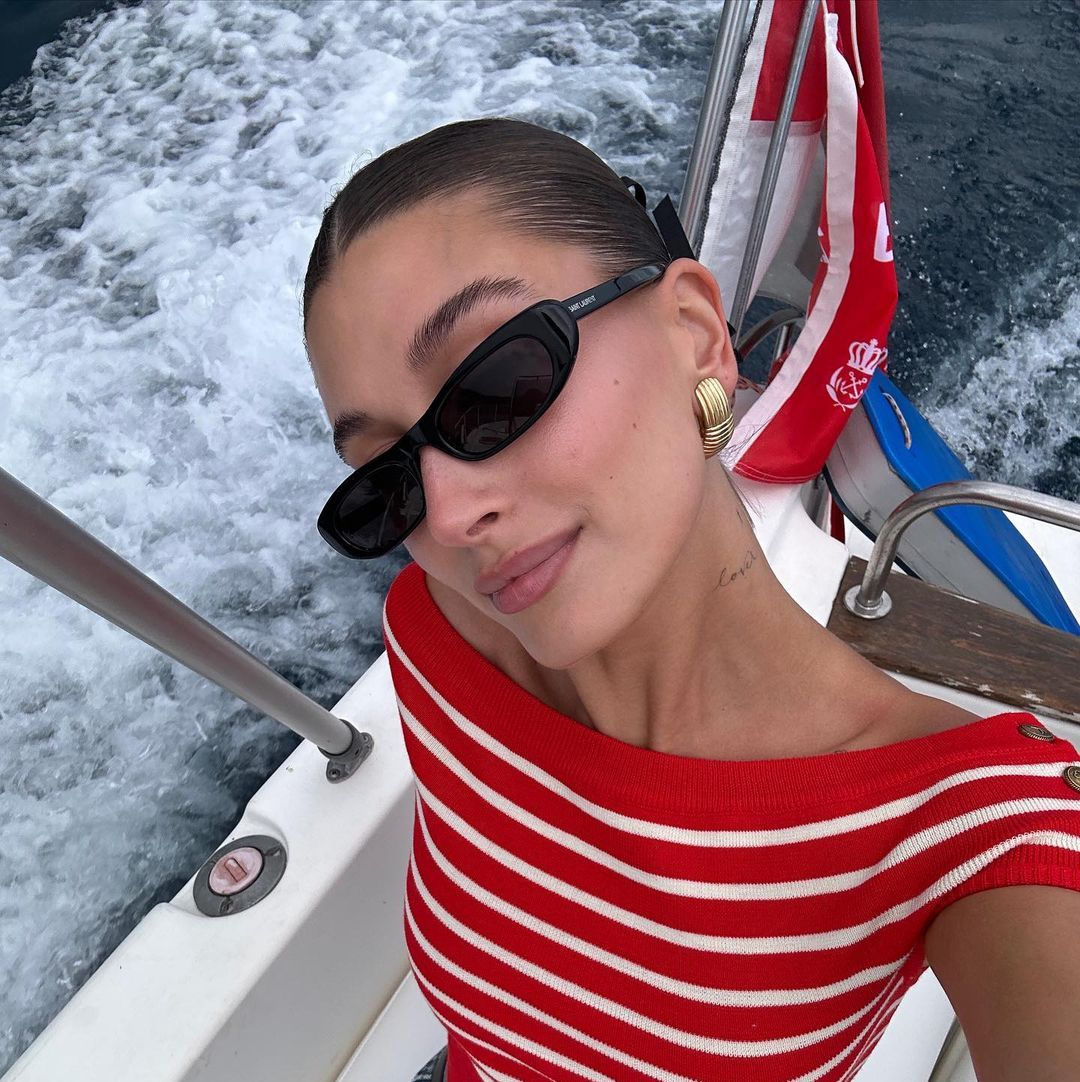 Hailey Bieber's Vacation Wardrobe Includes Nautical Tops and Sheer Cardigans
