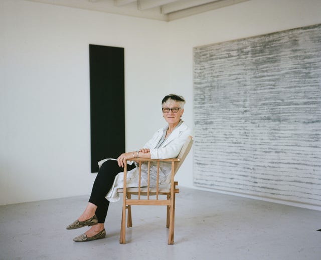 a person sitting in a chair in front of a whiteboard