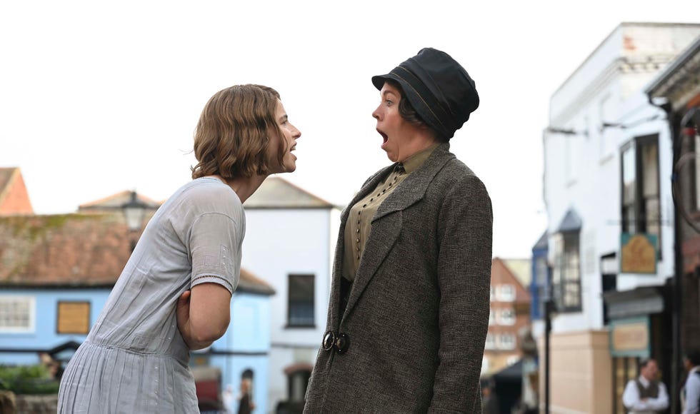 a man and woman standing next to each other in a city