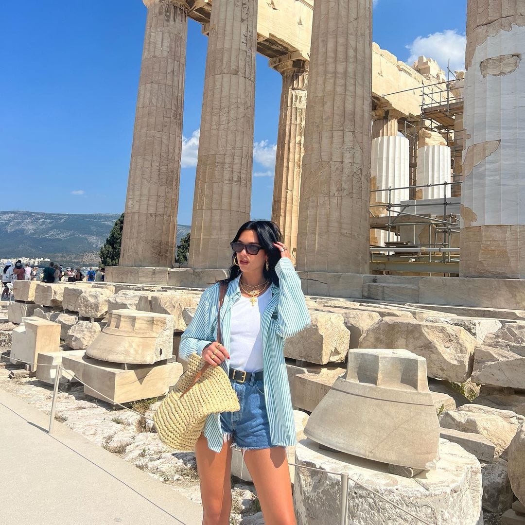 See Dua Lipa Pair a Striped Button Down and Denim Shorts in Greece