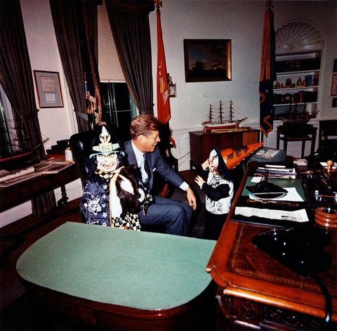this photograph by cecil stoughton shows caroline kennedy and john f kennedy, jr visiting president john f kennedy in the oval office on halloween in their costumes