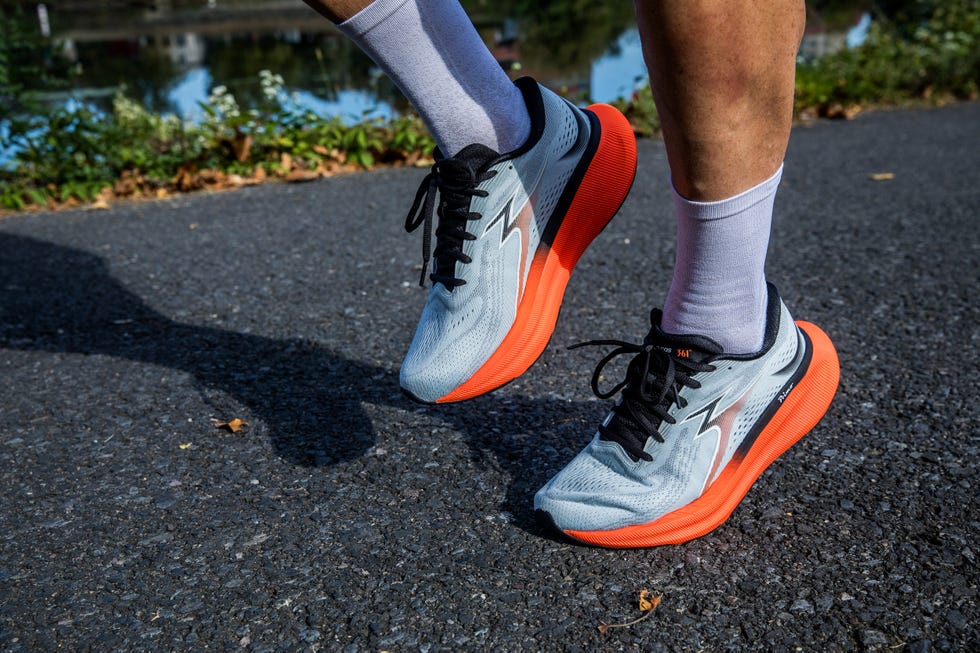 running shoes on a pavement with greenery in the background