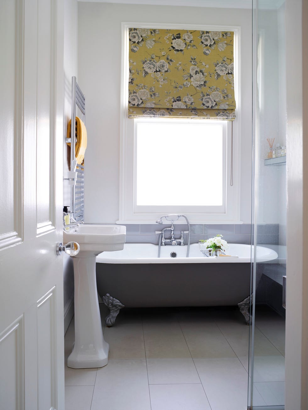 Bathroom: A palette of white and grey is brightened up by a yellow blind by Helen Turkington, while the bath looks chic in Farrow and Ball's Mole's Breath.