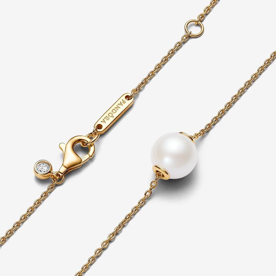 a gold chain with a round ball