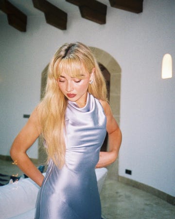 woman wearing a sleek lavender dress in a modern interior