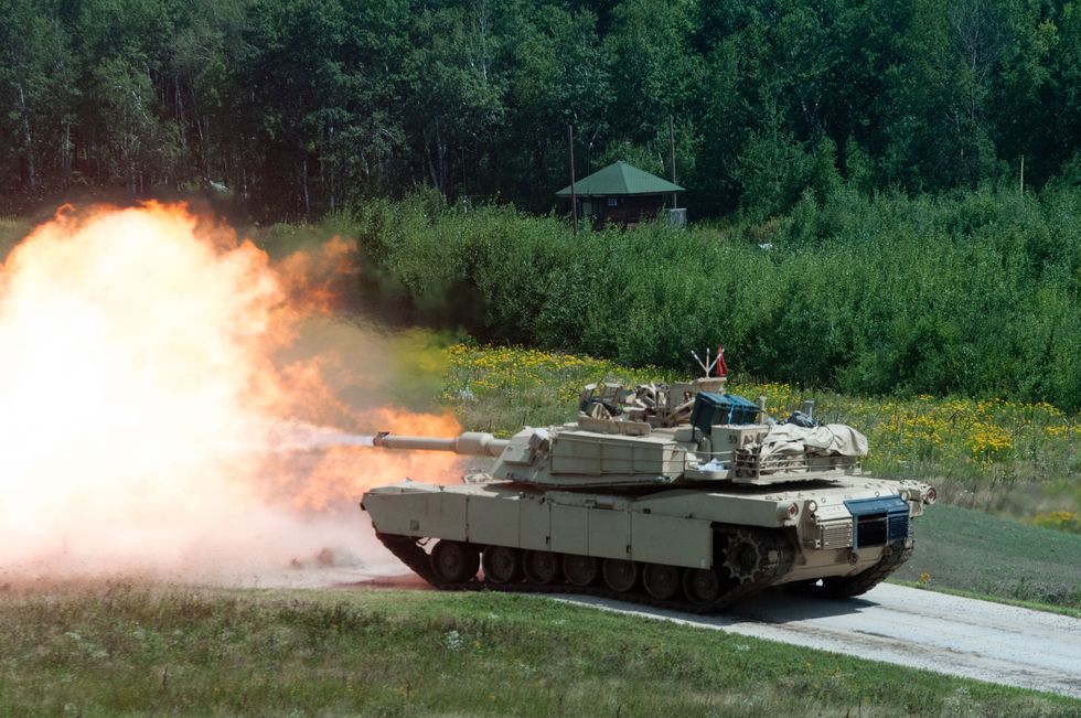 an abrams tank fires during a gunnery proficiency table august 4 2017 during annual training at camp ripley, mn the exercise is designed to test the skills of tank crews as they maneuver and engage stationary and moving targets up to a mile away