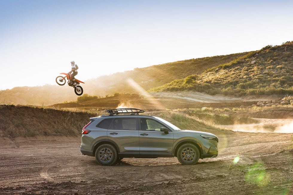 a motocross rider jumping a honda cr v