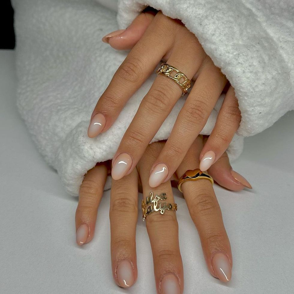 a woman's hand with rings on it