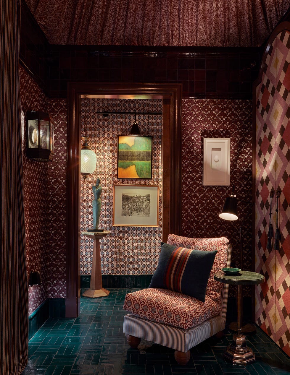 Cozy corner in a patterned room with seating and decorative elements.