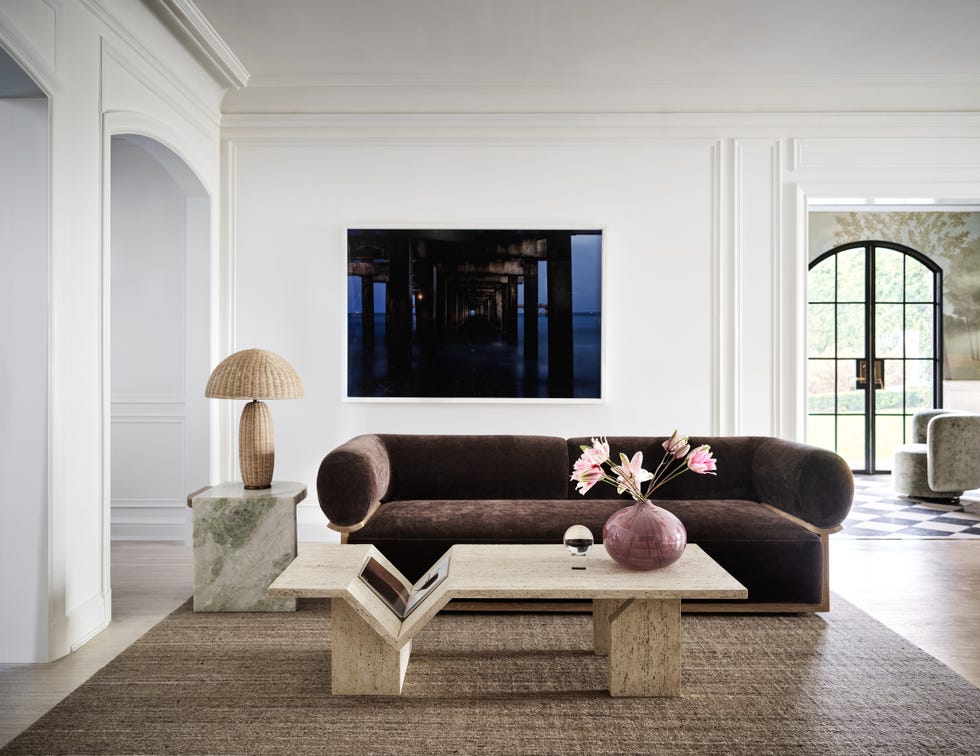 Modern living room featuring a sofa, coffee table, and decorative elements.