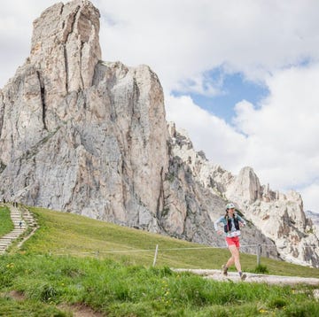 Lavaredo Ultra Trail a person walking on a trail in front of a mountain