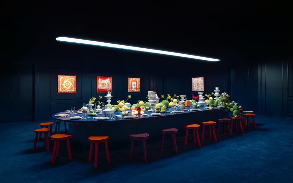 An elaborate dining setup with a long table filled with various food items and dishes.