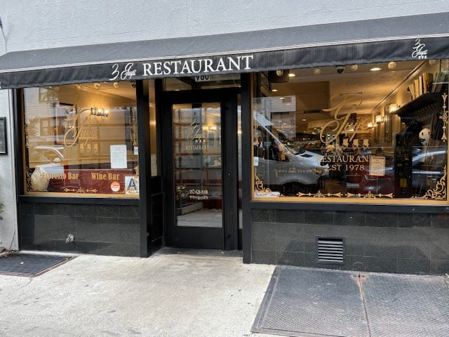 Restaurant entrance featuring a name sign and visible dining area.