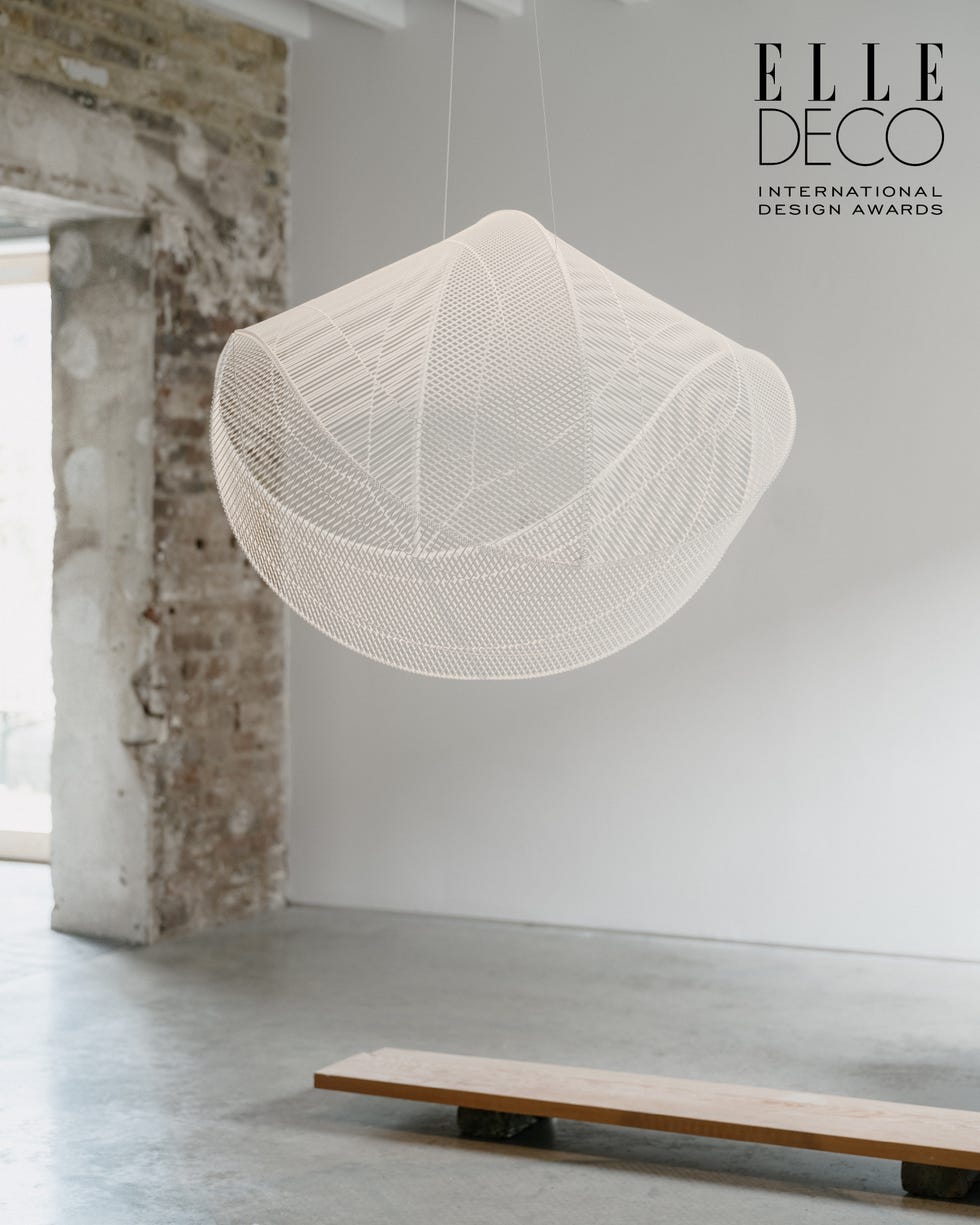 Hanging light fixture in a minimalist interior space Hanging light fixture in a minimalist interior space