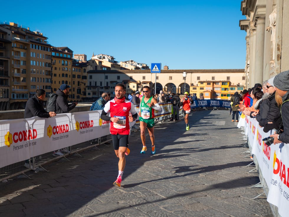 runners participating in a race surrounded by spectators in a city setting
