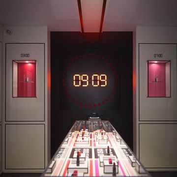 a red and white checkered table with a digital clock on it