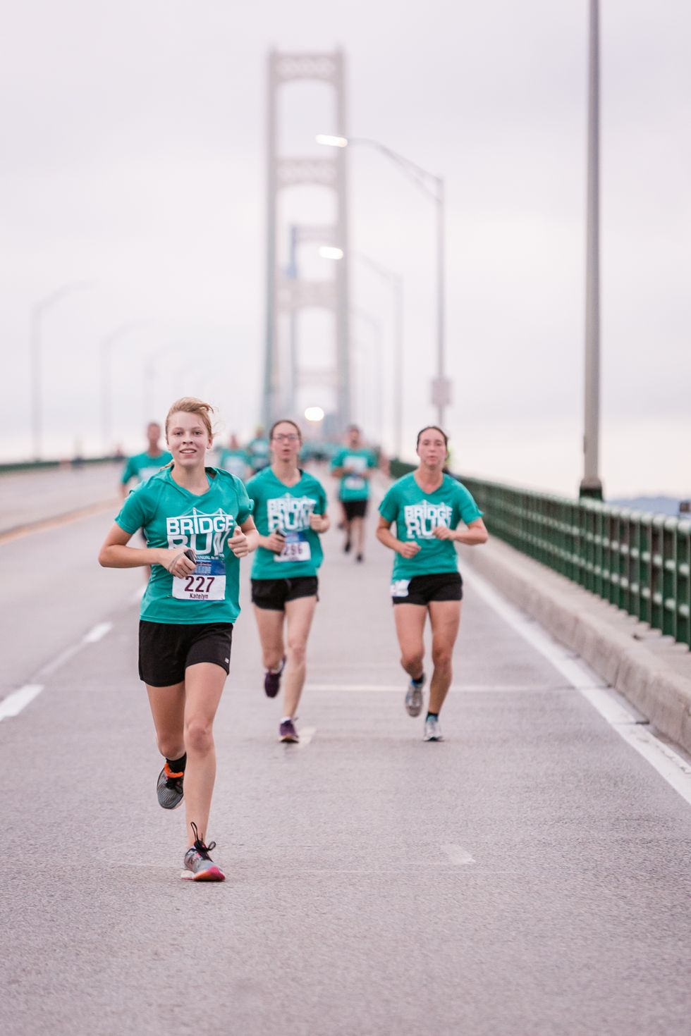 runners cross the bridge in the labor day mackinac bridge run