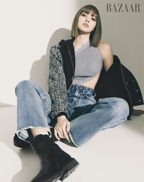 lisa from blackpink wears a knit sweater and jeans by celine