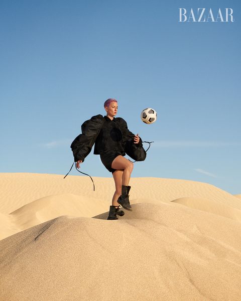 megan kicks ball on sand dune