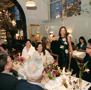 a group of people sitting at a table with candles