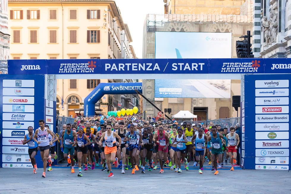 a group of people running on a street
