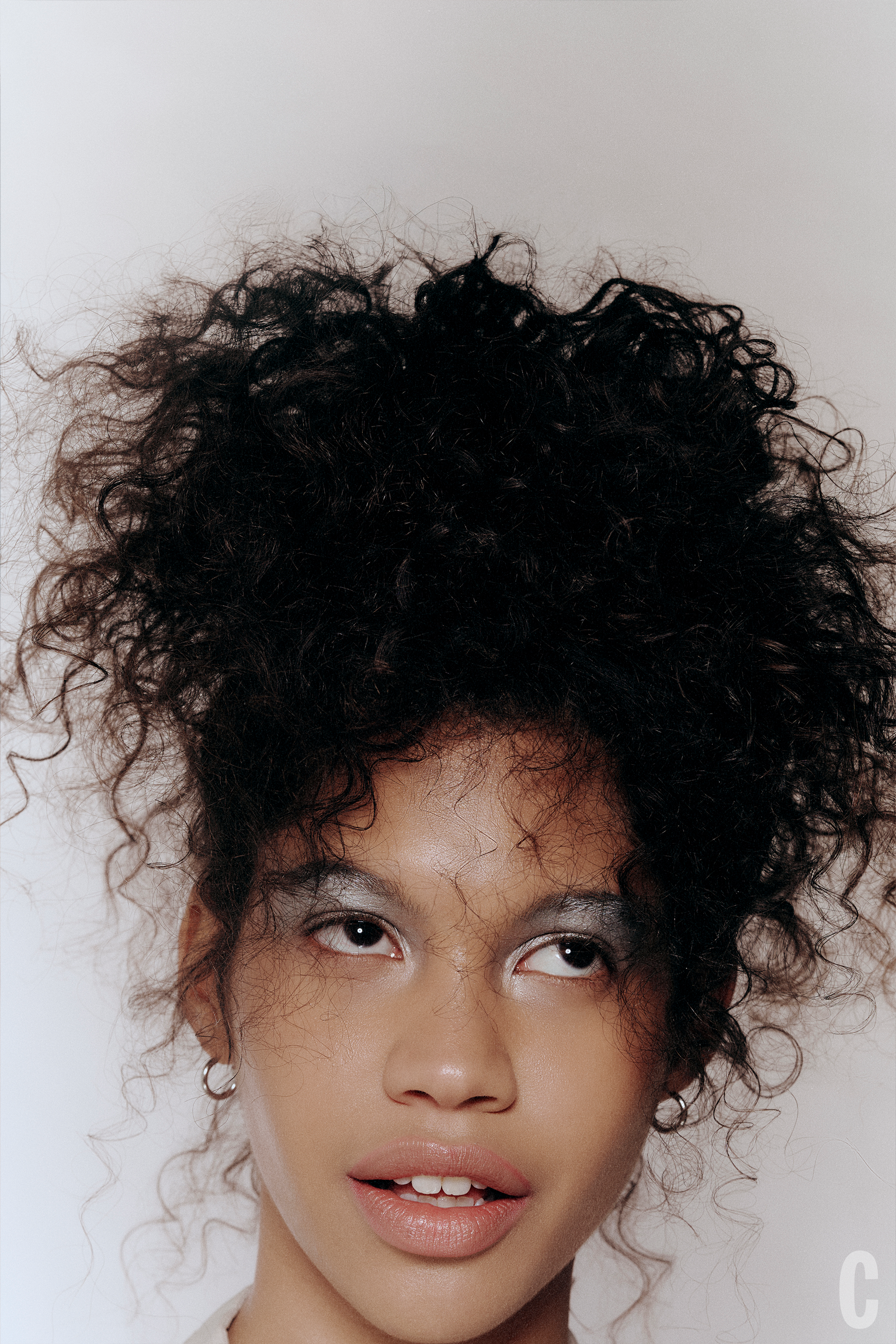 close up of woman with curly hair close up of woman with curly hair