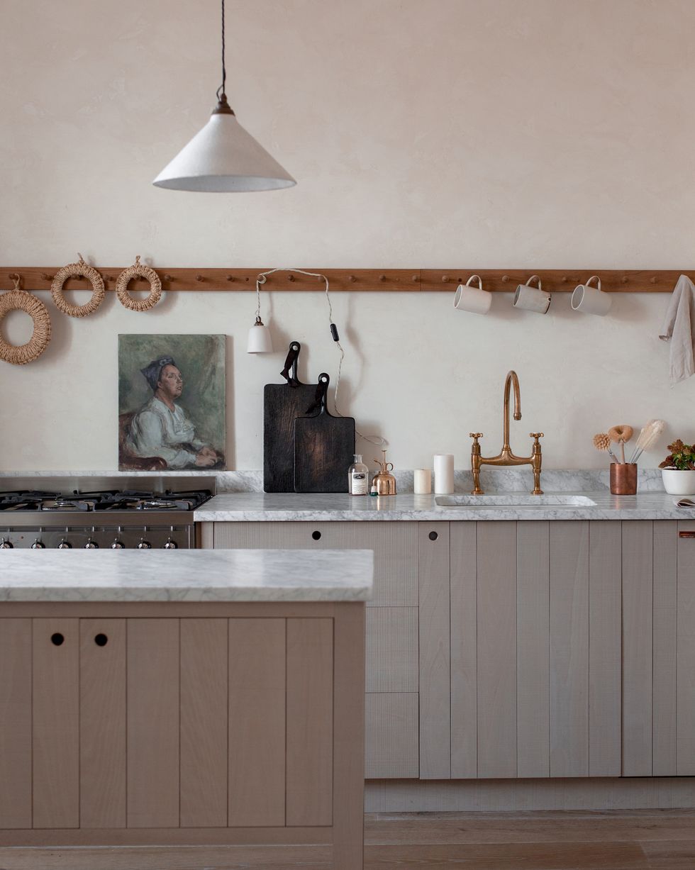 a pale wood kitchen with peg rail for storage