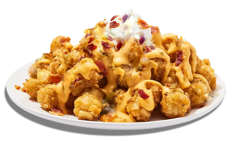 a plate of loaded potato bites topped with cheese sauce bacon bits and sour cream