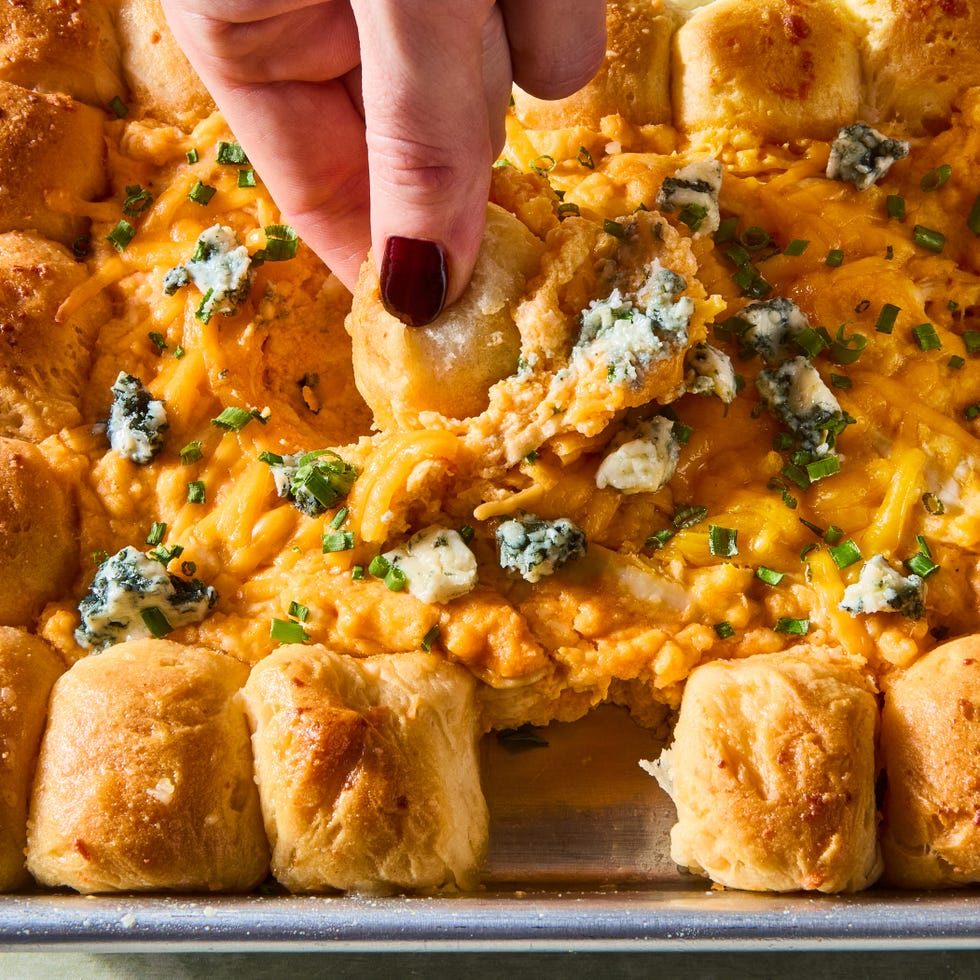 dip in 4 sections surrounded by pull apart biscuits on a tray