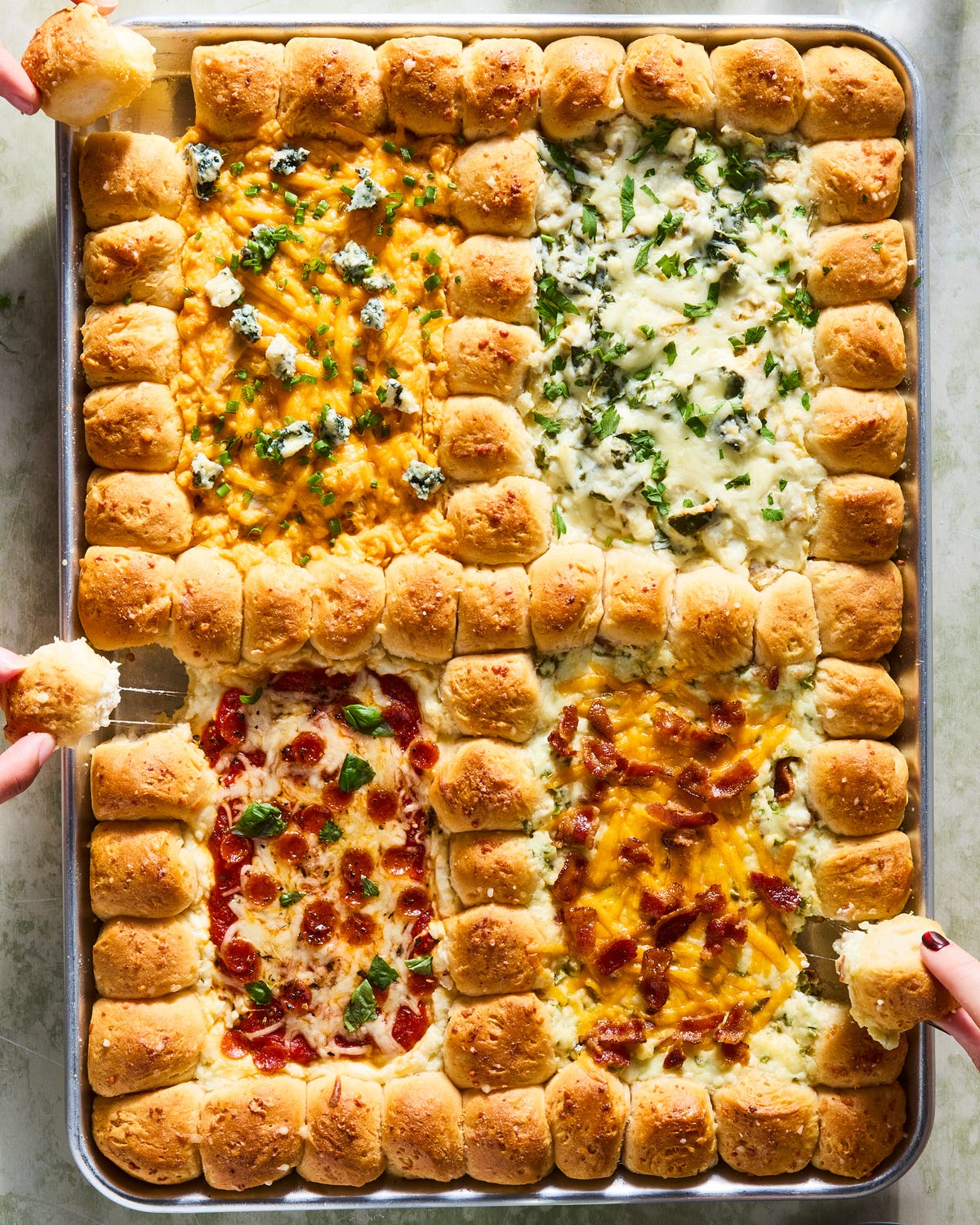 dip in 4 sections surrounded by pull apart biscuits on a tray